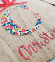 Load image into Gallery viewer, Personalised Christmas Oak Veneer Ornament - Liberty Print Inital and Red Holographic Vinyl - Red Ribbon Trims - BoutiqueCrafts
